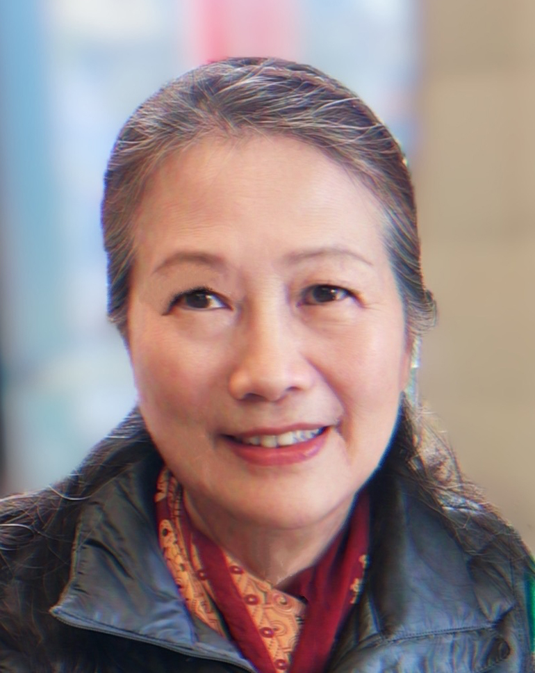 Portrait of a woman with her hair pulled back wearing a black jacket